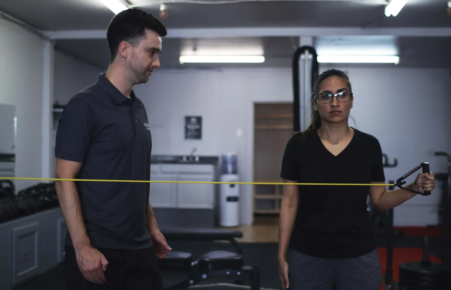 Registered kinesiologist guiding a client through exercise-based rehabilitation at Kenaz Training in Langley BC