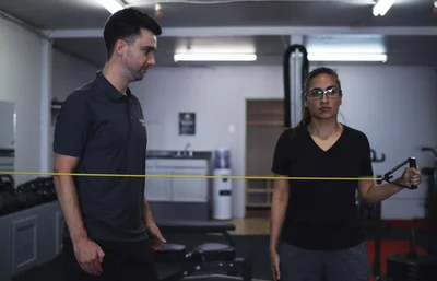 Registered kinesiologist guiding a client through exercise-based rehabilitation at Kenaz Training in Langley BC